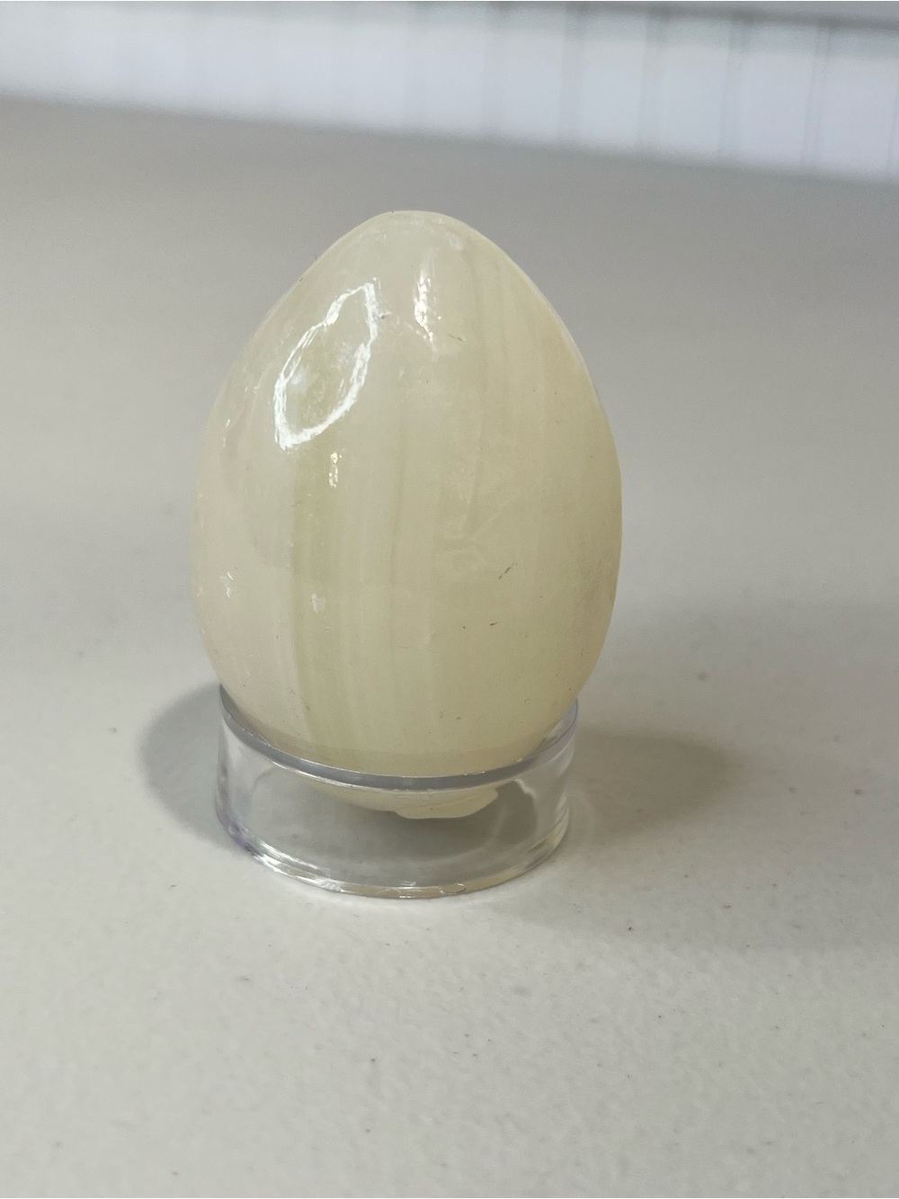 Cream Decorative Banded Calcite Egg on Clear Stand